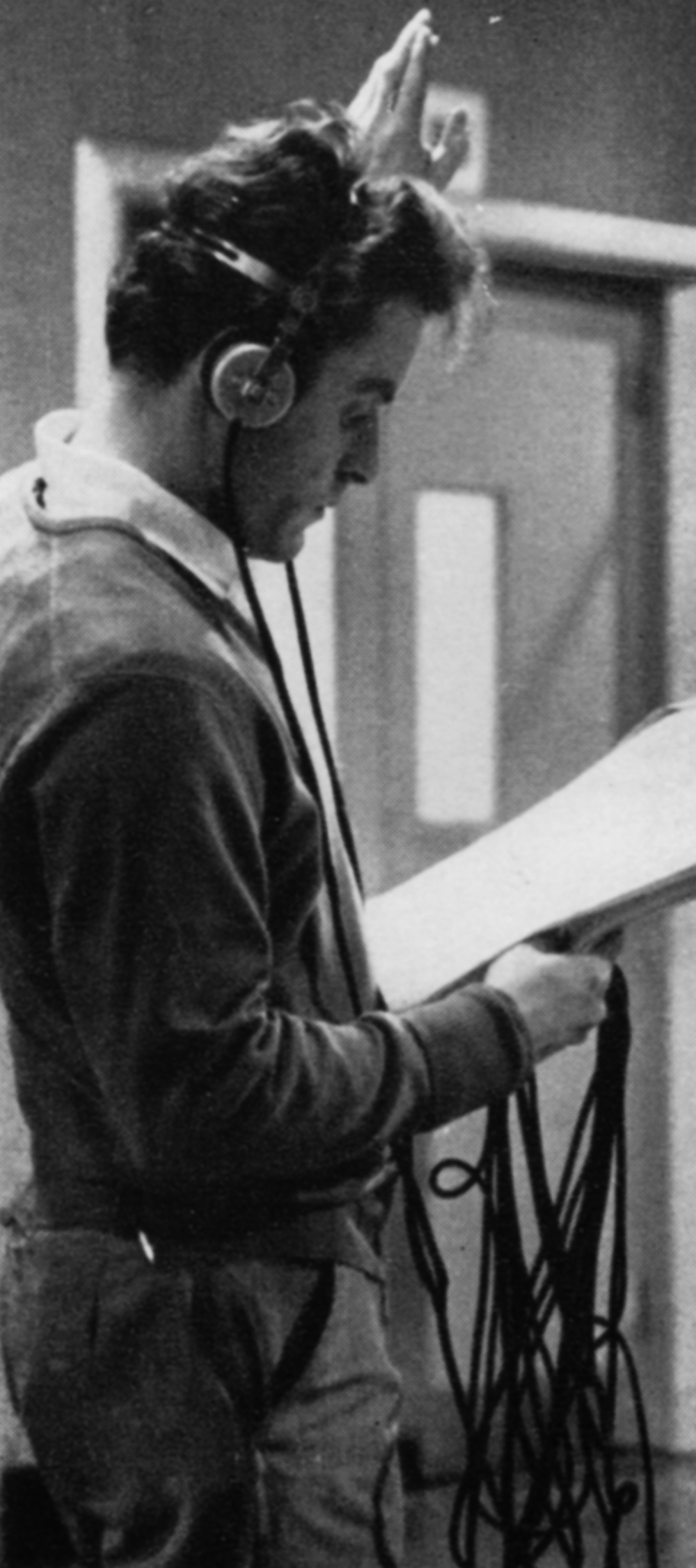 Floor manager in headphones holding a script